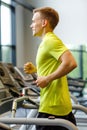 Smiling man exercising on treadmill in gym Royalty Free Stock Photo