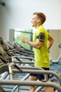 Smiling man exercising on treadmill in gym Royalty Free Stock Photo