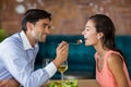 Smiling man feeding meal to woman Royalty Free Stock Photo