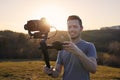 Portrait of happy videographer with camera and gimbal Royalty Free Stock Photo