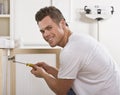 Smiling Man Fixing Cabinet Door Royalty Free Stock Photo