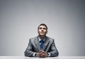 Smiling man folded hands and looking upward. Royalty Free Stock Photo