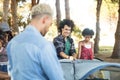 Smiling man with friends setting up tent