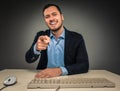 Smiling man is gesturing with hand, pointing finger at camera Royalty Free Stock Photo