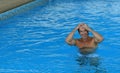 Smiling man getting out of blue swimming pool wate Royalty Free Stock Photo