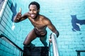 Smiling man getting out the pool Royalty Free Stock Photo