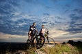 Smiling man and girl sitting on mountain bikes and smiling. Royalty Free Stock Photo