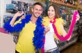 Smiling man with girlfriend wearing feather boa Royalty Free Stock Photo