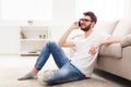 Smiling man in glasses at home with mobile Royalty Free Stock Photo