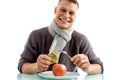 Smiling man going to eat apple with fork and knife