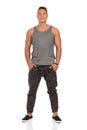 Smiling Man In Gray Tank Top And Camo Pants