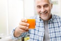 Smiling man having a glass of orange juice Royalty Free Stock Photo