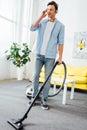 Man in headphones cleaning carpet with