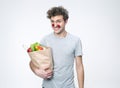 Smiling man holding a bag full of groceries Royalty Free Stock Photo