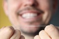 Smiling man holding dental floss in his hands Royalty Free Stock Photo