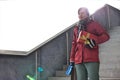 Smiling man holding gifts while moving down steps