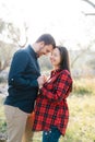 Smiling man holding hands of pregnant woman touching his forehead to her forehead Royalty Free Stock Photo