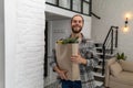 Man holding paper grocery shopping bag full of fresh healthy food vegetables in his hand. Royalty Free Stock Photo