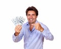 Smiling man holding and pointing cash dollars