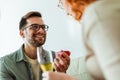 Man holding red box with marriage engagement ring and make proposal to happy girlfriend