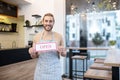 Smiling man holding sign that says open Royalty Free Stock Photo