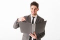 Smiling man in jacket holding folder and pointing on it Royalty Free Stock Photo