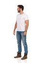 Smiling Man In Jeans And White T-shirt Is Standing And Looking Away. Side View Royalty Free Stock Photo