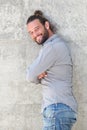 Smiling man leaning against wall with arms crossed Royalty Free Stock Photo