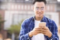 Smiling man listening music and  using mobile phone while walking Royalty Free Stock Photo