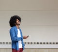 Smiling man listening to music from mobile phone Royalty Free Stock Photo