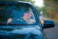 Smiling man looking from a car window Royalty Free Stock Photo