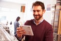 Smiling man looking at a CD in a record shop