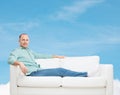 Smiling man lying on sofa Royalty Free Stock Photo