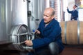 Smiling man machinery operator working in winery