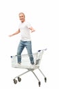 smiling man with outstretched arms standing in shopping cart