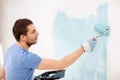 Smiling man painting wall at home Royalty Free Stock Photo