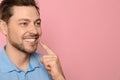 Smiling man with perfect teeth on color background. Royalty Free Stock Photo