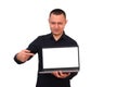 Smiling man pointing his finger at a blank laptop computer screen. isolated on a white background.