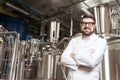 Smiling man posing with brewing mechanisms