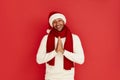 Smiling Man Prayer Gesture. Handsome Multiracial Man Wearing Santa Hat Praying