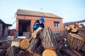 Smiling man reaching for a log