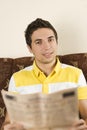 Smiling man read newspaper