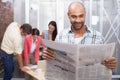 Smiling man reading the newspaper Royalty Free Stock Photo