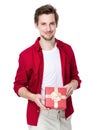 Smiling man in red jacket with gift box Royalty Free Stock Photo
