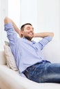 Smiling man relaxing on couch at home Royalty Free Stock Photo