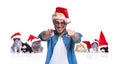 Smiling man with santa cap points finger near christmas cats Royalty Free Stock Photo