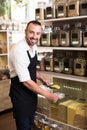 Smiling man seller standing with cereals sold Royalty Free Stock Photo