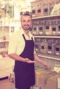 Smiling man seller standing with cereals sold Royalty Free Stock Photo