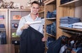 Smiling man shopper choosing new suit Royalty Free Stock Photo