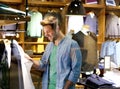 Smiling man shopping for clothes at clothing store